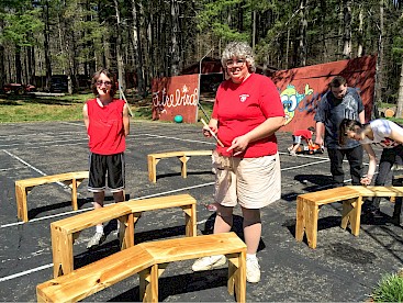 Norita (an alum) refinishing dining hall benches